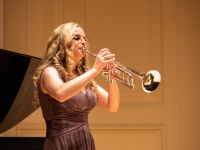 student playing intrument inside